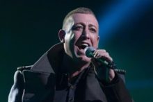 Liverpool's Chris Maloney is through to the next stage of X Factor amid a war of words between judges Gary Barlow and Tulisa.