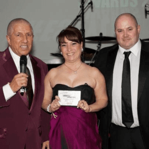 Denise Fergus collecting her 'Outstanding Person' award from Radio City DJ Pete Price (left) © Amanda Moss