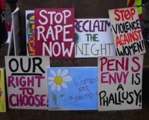 Protesters' signs that read 'stop rape now'