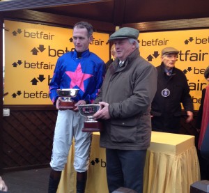 Colin and Joe Tizzard celebrate after Cue Card wins the Betfair Chase