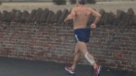 A mystery runner has been spotted sprinting around Liverpool, wearing just a pair of gloves and running shorts.