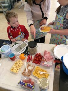 Families and children making their own pizzas at Pass the Book workshop © OneArkLaura/ Twitter