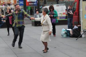 Writer of the single Ian Hewitt and the Lord Mayor, Councillor Erica Kemp dancing in Williamson Square
