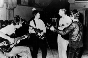 George Martin (third from left) with The Beatles in the Abbey Road studios in 1966. Pic © Capitol Records / Wikimedia Commons