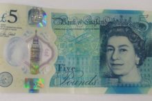 A woman hopes to get more than £1,500 after selling a rare £5 note with a misprint on the new plastic currency.