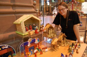 Liverpool Cathedral shop assitant with some of the Nativity sets ©Facebook-Liverpool Cathedral