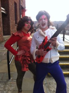 Performers from Hope Street Ltd Productions pose with their inflated guitar