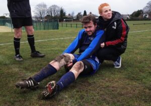 Bill Evans is comforted by Shannyn Quinn after suffering another cruciate ligament injury