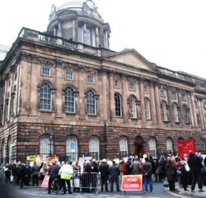 Protesters gather outside Liverpool Town Hall at the council's budget meeting