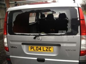 The smashed back window of the van where the equipment was left.