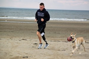 Andy Grant in training on a local beach with canine company © AG Motivation