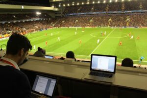 Dan Wright working at Anfield covering Liverpool's Champions League decider against Basel. Pic by Connor Dunn © JMU Journalism