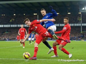 Liverpool's Joe Allen tangles with Everton's Kevin Mirallas as surprise Reds starter Jordon Ibe watches on in the Merseyside derby at Goodison Park. Pic © David Rawcliffe / Propaganda Photo