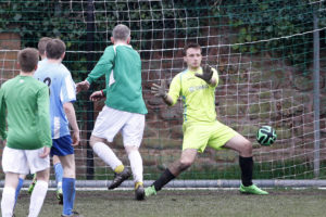 Jeff McGlinchey heads in the opener for the Alumni past Level 2 goalkeeper Tom Begbie. Pic © Craig Galloway
