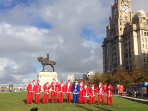 Santas lining up by the Liver Building at the Santa Dash launch. Pic by Rosie Steedman © JMU Journalism