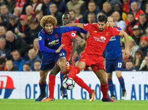 Manchester United's Marouane Fellaini challenges Liverpool's Emre Can at Anfield. Pic © David Rawcliffe Propaganda Photo