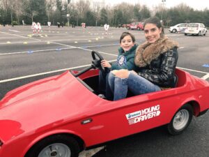 Young driver at the wheel with his mum at a Haydock Park event. Pic by Andrew Nuttall © JMU Journalism