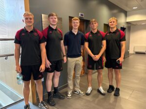 Wigan Warriors players with JMU Journalism sports student Adam Bradshaw (centre) on their media training day at Redmonds