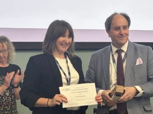 Polly Sharpe receives the LJMU Faculty of Society and Culture Award from Pro-Vice-Chancellor, Timothy Nichol