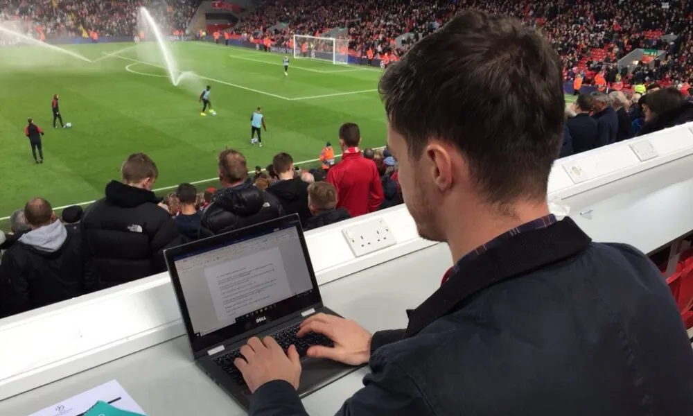 Joe Maude working in the Anfield press box on a Champions League night - JMU Journalism